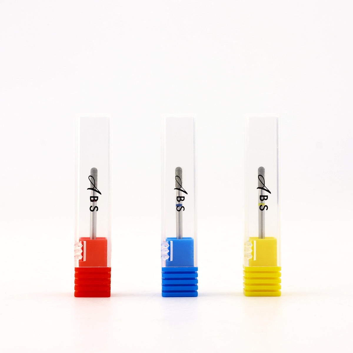 Three dental impression trays in clear plastic with colored bases in red, blue, and yellow, each containing a metal impression material tube labeled 'ABS', set against a plain white background.
