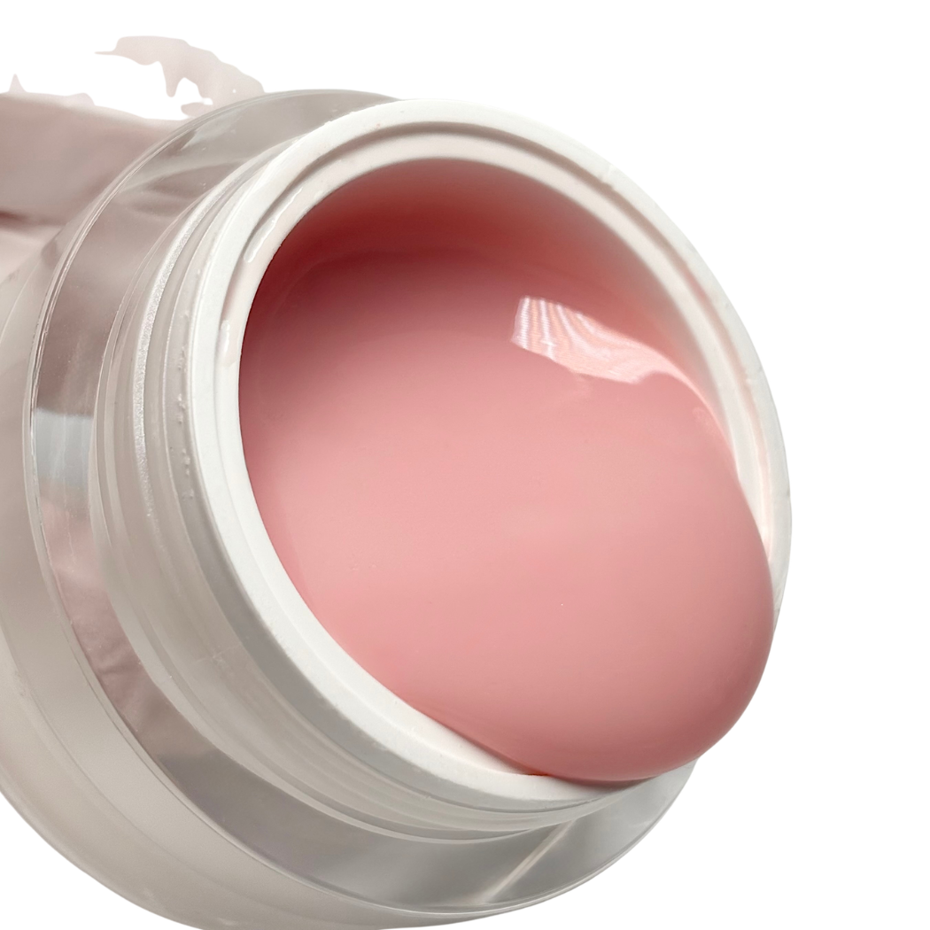 Pink lip balm in a transparent container on a white background